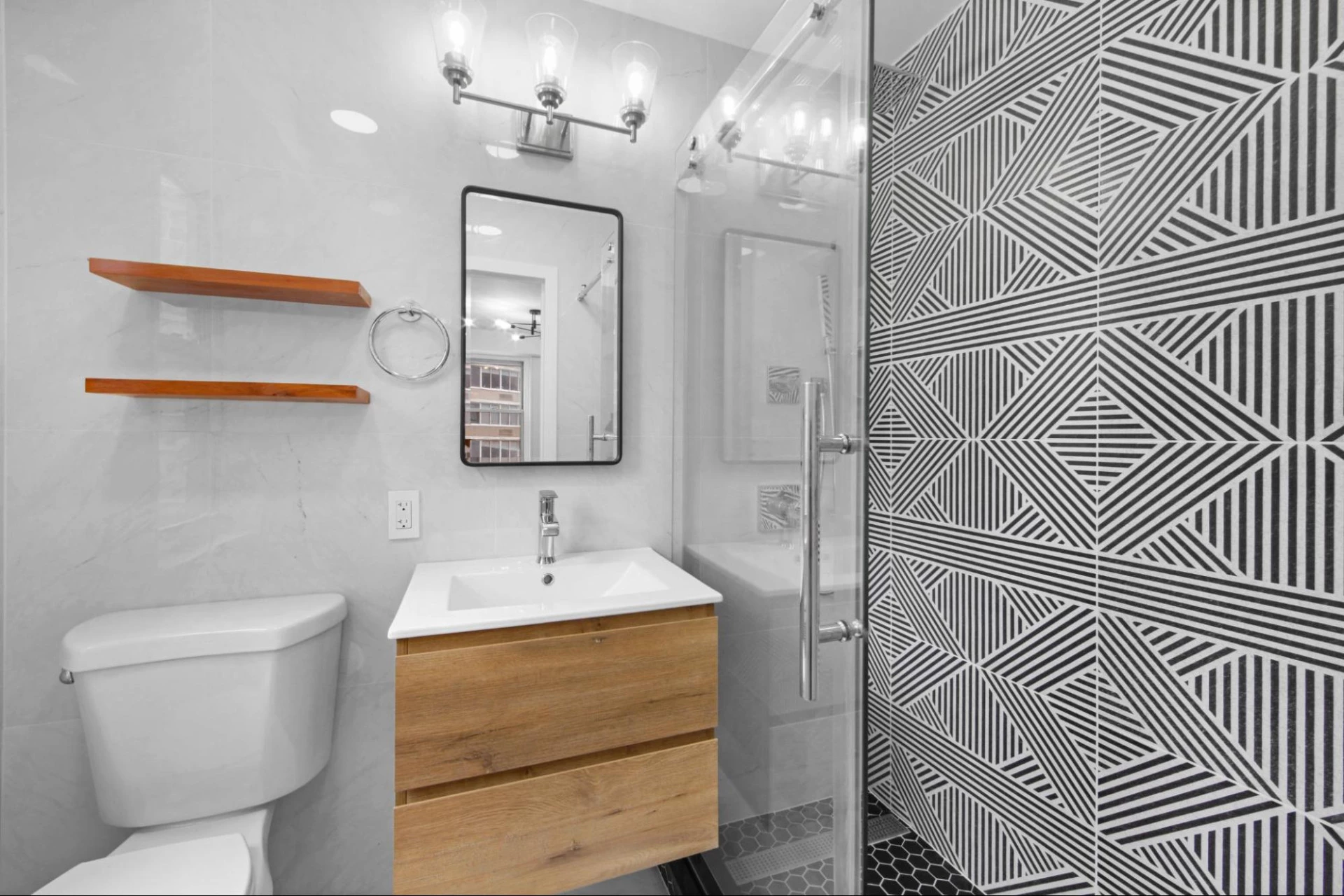 Floating vanity and shelves, frameless shower door, large-format light gray tile